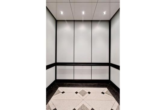 LEVELe-105 Elevator Interior with main panels in ViviChrome Chromis glass with White interlayer and Opalex finish; handrail panels in Fused Graphite with Sandstone finish; Round Handrails in Oil-Rubbed Bronze at the Brandywine Building, Wilmington, Delaware
