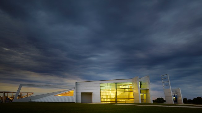 The north entry façade glows like a porch light awaiting guests.