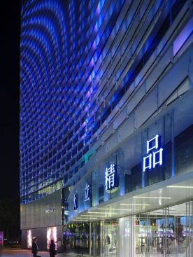 View of the building entrance. The fa??ade acts as a luminous curtain that constantly changes colors while welcoming the visitor.