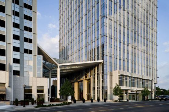 Positioned between the tower and the parking garage, a large open canopy serves as both a covered entrance to the lobby and an exterior space for events.