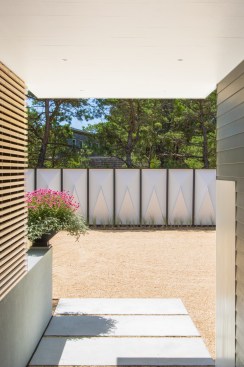 Autocourt with acoustic panel screen walls, salvaged from a NYC parks amphitheater.
