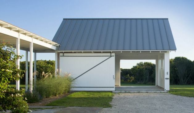 Sliding barn doors give the detached garage a distinct flavor of the farm.