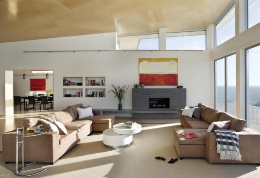 Sloped ceilings soar up toward ocean vistas and lower down into more personal interior spaces.