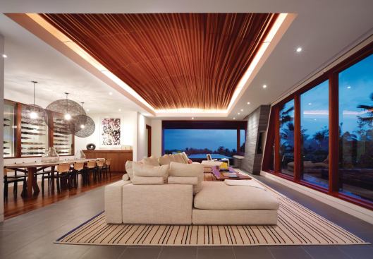The living room’s CNC-cut glulam ceiling evokes a grass skirt.