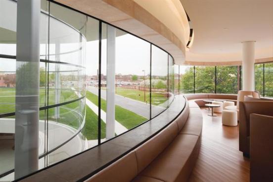 The other three dining spaces are found in The Commons. On the south side is a more formal dining room; in the middle, above the green stair, is a long bar; and to the north is a more casual coffee housestyle environment (shown). All of these spaces have views to the plane. In contrast to the light tones and finishes of Fortaleza Hall, the spaces in The Commons feature a much warmer materials palette. Bamboo floors and rich brown leathers "give a greater sense of warmth and uniqueness to those spaces," Robinson says. And they get a lot of use; the employee reaction has been overwhelmingly positive. "The employees are wowed," Semrau says. "The space is packed every day, and it is a hub of activity."