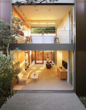 The owner uses the new pavilion as a ground-floor den, a second-level master suite, and a top-floor solarium that pops up over the trees.