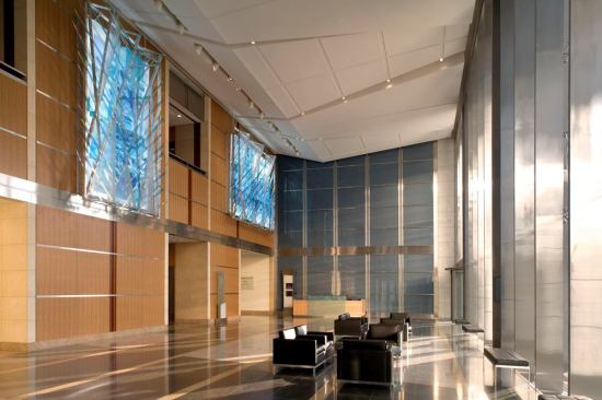 The V-shaped ceiling panels carry into the lobby illuminating the interior surfaces.