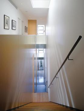 The stairway occupies a slice of the building that extends from front to rear through all three stories. 