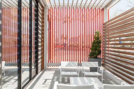 A steel trellis composed of rectangular tube steel sections protects the building from south sun exposure, while creating a canopy that highlights the entry and provides safe respite for showroom users and visitors.