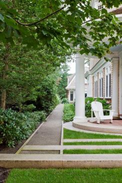 The 1-inch-deep crushed granite was installed over an 8-inch base of 3/4-inch stone. A matching flush-granite curb, 3 inches wide and 12 inches deep, creates a solid permanent edge.