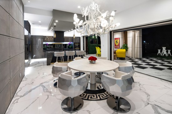 Crystal chairs and an alligator-embossed table by Fendi Casa.