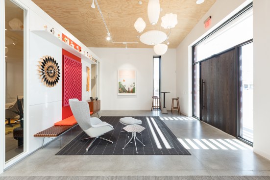 A series of existing interior skylights provide daylighting and LED lighting is provided throughout. Existing concrete floors are grinded and polished within the reception area, living room, and kitchen. Exposed aggregate concrete floors occur at the exterior entry and patio. 