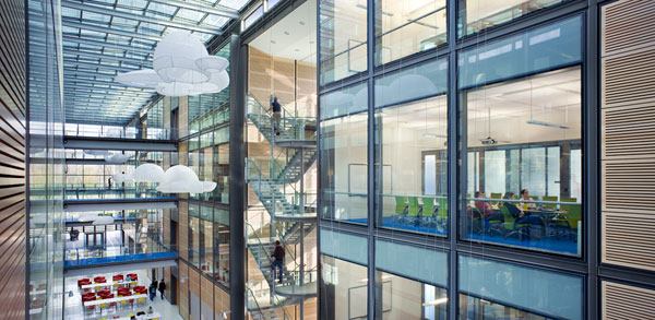 A view of the atrium. Downlights in custom-metal ceiling panels coordinate with the bridges and the stairs.