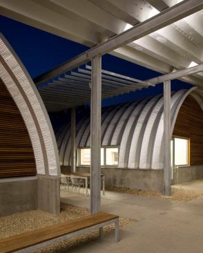 Since this is a 24-hour manufacturing facility, lighting from the interior spaces also helps to provide some exterior lighting in the covered walkway areas.
