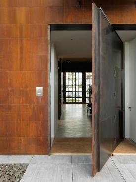 The larger door links the entry courtyard to a private courtyard at the opposite side of the house.