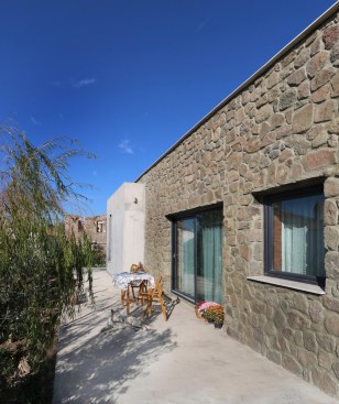 perspective showing the terrace and the willow tree in front of the glass door, providing shade in summers