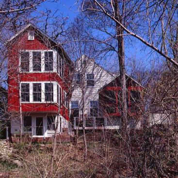 Architects: Christine Albertsson, Todd Hansen, Albertsson Hansen Architecture, Ltd., Minneapolis, MN &nbsp; Homeowners with a growing family needed to expand their 1,100 s.f. house.Architects added to the existing house in ways&nbsp;that increased privacy but still allowed access to the park and creek below.The addition design brings together the elements of a small, New England saltbox with the red board and batten siding of a Swedish Stuga.