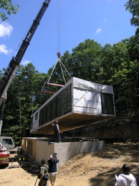 Prefab module being set by crane.