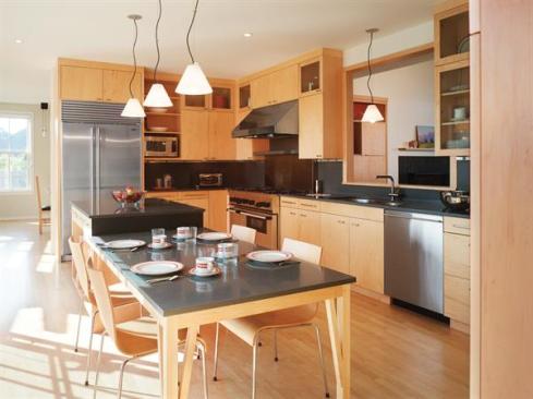 Credit: Warren Jagger Maple flooring, cabinets, and built-in furniture streamline the interior. Light-green plaster walls and slate countertops complement the exterior trim.