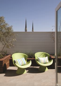 Outside, the home's original concrete patio was broken up and reused to build a dry-stack wall in the yard, original roof beams were repurposed into planter boxes, and chimney brick gained a second life in the patio's floor, as seen on the upper deck.