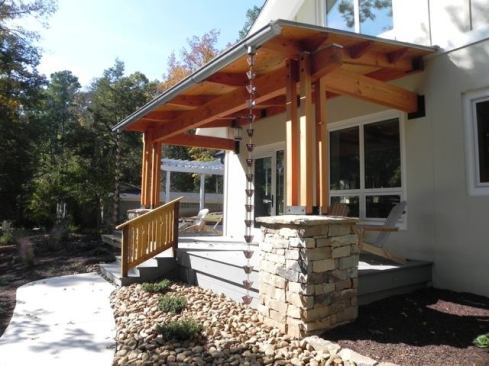 Details like a rain chain hanging from the gutter manage water runoff to help take care of the garden.