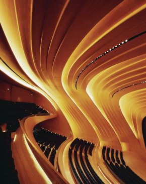 The+backlit+oak+panels+in+the+conference+center%e2%80%99s+1%2c000-seat+auditorium+bring+warmth+to+the+otherwise+vividly+white+interior.+
