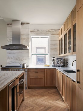 Kitchen with custom Henrybuilt cabinets and Bianco Lassa marble backsplash and counters