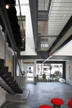 The homes interiors are marked by materials that reference an industrial pedigree with raw and exposed steel, concrete masonry units, and exposed structural framing.