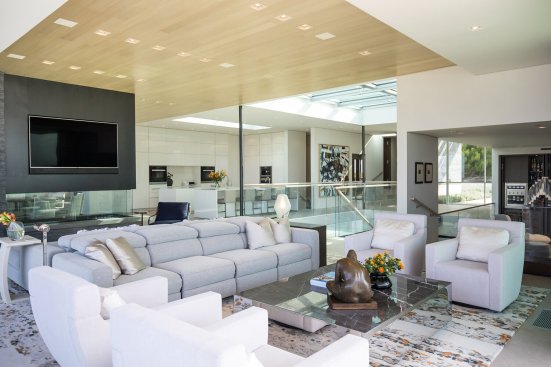 Modern Beverly Hills home living room open to kitchen, library and front entry.