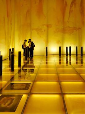 Interior of the Lithuanian pavilion, featuring a minimal, amber-themed space