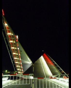 Slowly the white light shifts to red light as the bridge moves closer to its full open position.