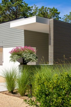 The owner, a landscape architect, designed this custom metal planter for the entry knee wall.
