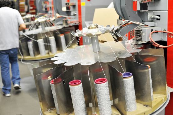 The excess yarn is sorted by color and unraveled as part of the reclamation process. The fiber will be re-melted, pelletized, blended, and then re-extruded back into fiber. According to Interface, this process uses half of the embodied energy that would otherwise be required to create new fiber from raw materials from the earth.