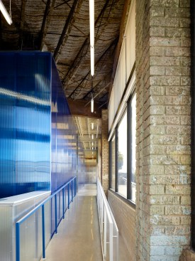 The existing clay tile firewall at the historic stair remains in place. 