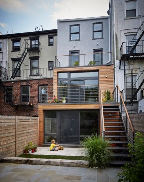 The new two-story addition at the rear is stepped so that it is deeper on the garden level, which keeps the lower floor from being in shadow.