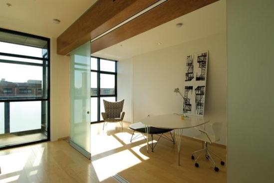 Movable glass partitions bring flexibility and borrowed light.