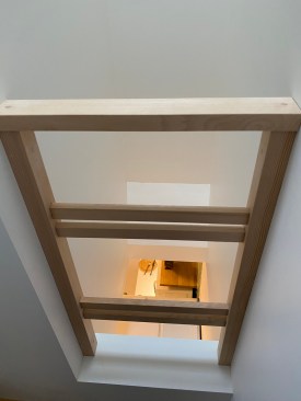View of the shaft space by the stairs upper landing. The kitchen is visible below.