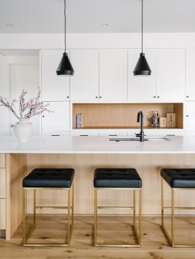 A Demure Color Palette with Splashes of Bold Black Characterize the Kitchen