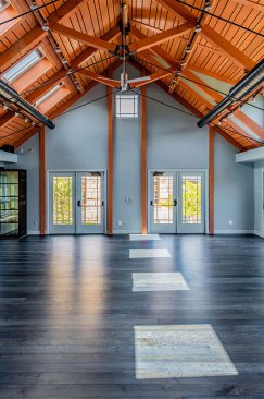 The project includes two large rehearsal rooms, a meeting/conference room, expansive back deck, small serviceable kitchen, laundry area, and bathrooms.