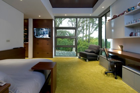 Sleek, modern bedroom design with floor to ceiling glass and bright colors.