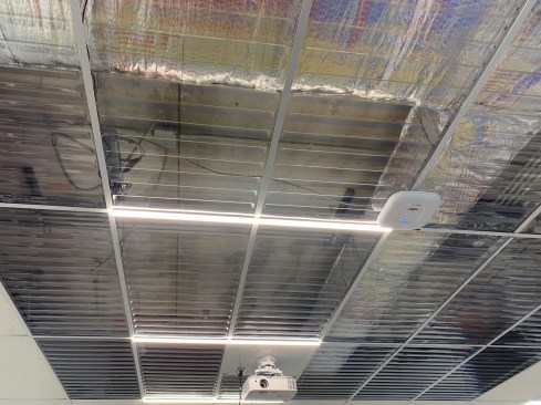 Clear panels in the middle school computer lab allow views of above-ceiling mechanical equipment and structural members, a metaphor for the computer “architecture” and an invitation to students to expand their creative vision.