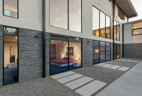 Walker Road modern home glass wall bedrooms that open to the pool terrace