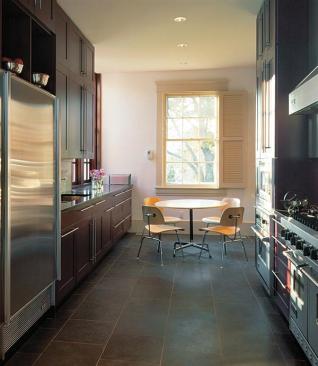 Original window frames and shutters in the remodeled kitchen help ease the transition between old and new sections of the house.