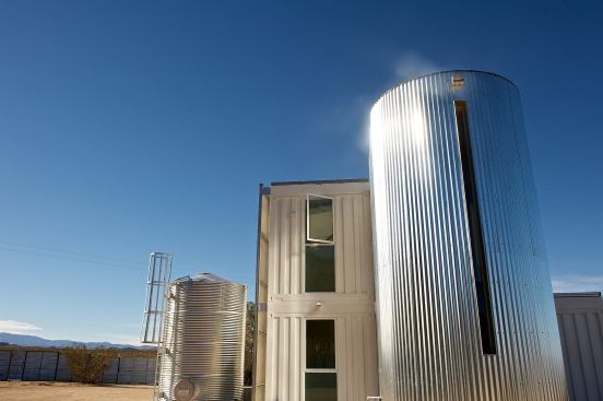 The stairway is curved and sheathed in recycled, corrugated metal with a vertical-slit window facing east to distribute morning light evenly across the walls of the 18-foot-high stairwell.