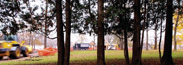 The black job trailer cuts a sleek, authoritative figure on a bustling job site. 