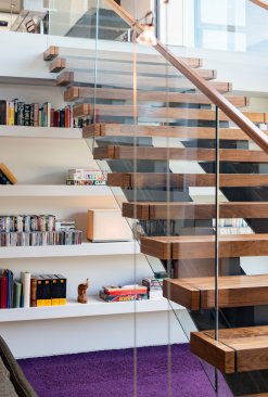 Walker Road modern home floating stairs above reading room library