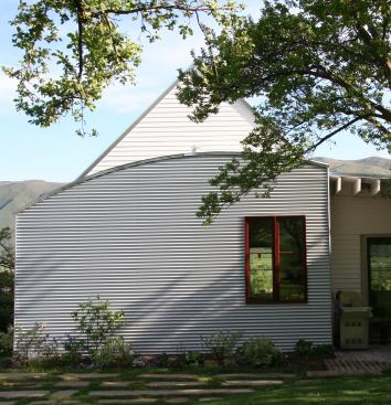At the north elevation, architect John Cottle stuck a gabled roof on two stories and then superimposed a curved roof and galvanized steel façade for the adjoining single story, calling to mind both the private houses and smelting kilns of Old Town Basalt.