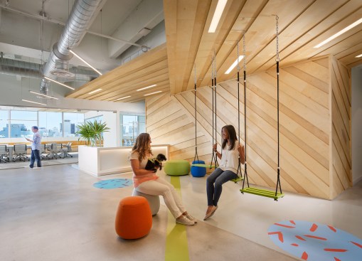 Bright green swings adorn the reception area of the pet-friendly Wix office.