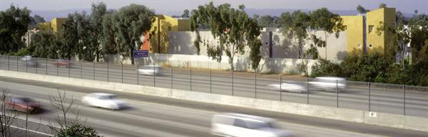 An attractive but anonymous freeway facade gives no hint of Tesoro Grove's lively interior, patterned with pedestrian courtyards, trellises, and thoughtful landscaping.