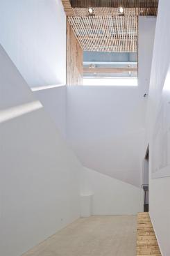 A double-height stairwell leads to the second level.